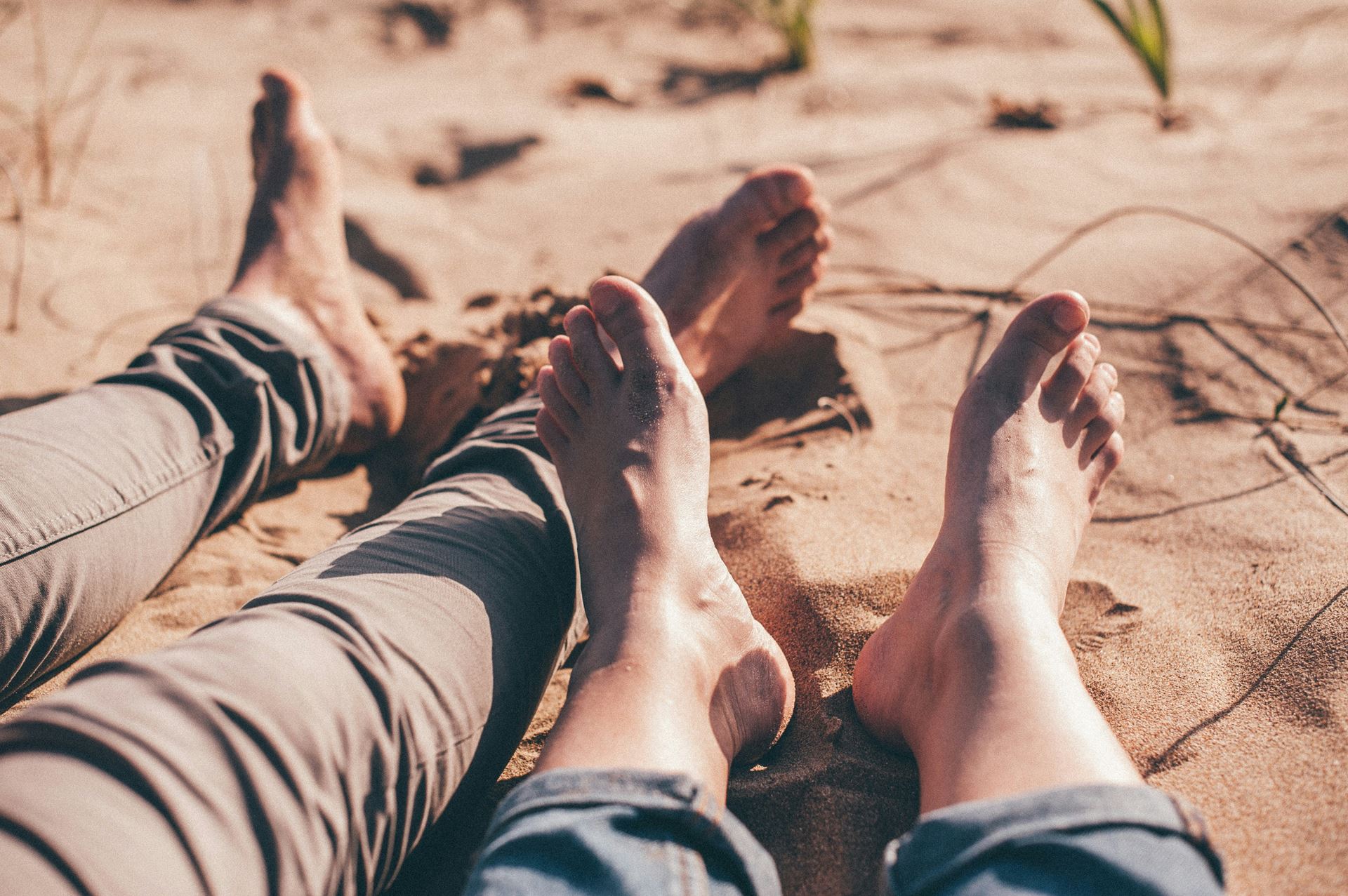 Two peoples bare feet on a beach